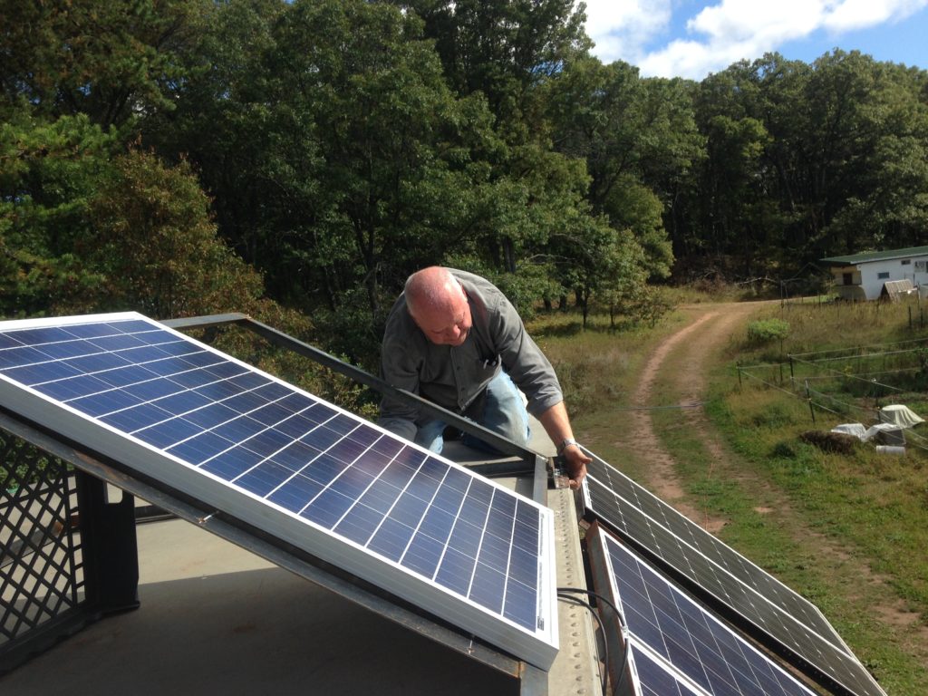 Kristin's dad Jim helping install the solar panels, using a frame he and his son Joe welded for us